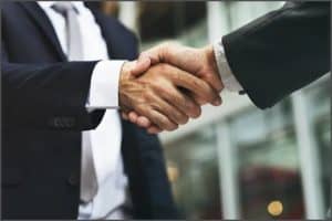 two business persons shaking hands stock image